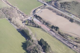 Oblique aerial view of Fountainhall showing construction of the Borders Railway Line, looking N.