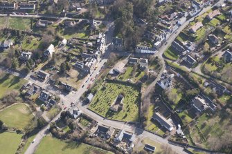 Oblique aerial view of Stow centred on Old Stow Kirk, looking ENE.