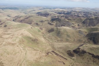 General oblique aerial view of Peelinick with the linear earthwork in the foreground, looking NE.