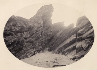 View of rock formations, including figure, on the beach of Kilchattan, Colonsay. Vignetted photograph
Titled: '143. Behind Kilchattan, Colonsay.'
PHOTOGRAPH ALBUM NO 186: J B MACKENZIE ALBUMS vol.1