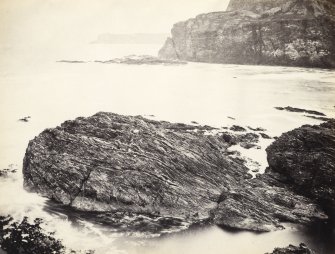 Wide view of rock formations and surrounding sea, on the beach of Kilchattan, Colonsay.
Titled: '153. Back of Kilchattan, Colonsay.'
PHOTOGRAPH ALBUM NO 186: J B MACKENZIE ALBUMS vol.1