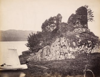 View of the ruins of the late medieval Finchard Castle with moored boat in the foreground, situated on the promontory near the south end of Loch Awe with the view of its eastern shore in the foreground, Lochawe, Kilmichael Glassary.
Titled: '166. Fincharn Castle, Lochawe.'
PHOTOGRAPH ALBUM NO 186: J B MACKENZIE ALBUMS vol.1