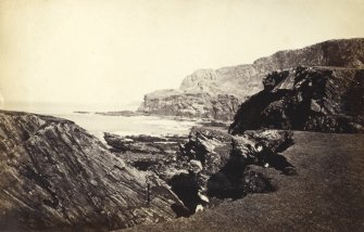 View of rock formations on the beach of Kilchattan, Colonsay.
Titled: '77. Rocks at the back of Kilchattan, Colonsay.'
PHOTOGRAPH ALBUM NO 186: J B MACKENZIE ALBUMS vol.1