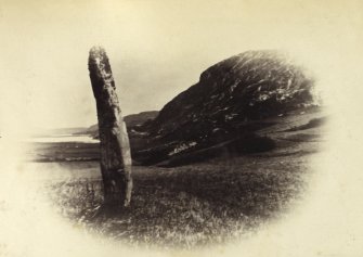 View of one of two standing stones, originally thought to have been part of a stone circle known as "Fingal's Limpet Hammers," at Lower Kilchattan, Colonsay.
Titled: '29. Pillar Stone at Kilchattan, Colonsay.'
PHOTOGRAPH ALBUM NO 186: J B MACKENZIE ALBUMS vol.1