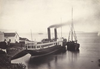 View of coaling steamship known as 'Chavalier' moored at Crinan Harbour, Crinan Loch, North Knapdale.
Titled: '41. "Chevalier" coaling at Crinan.'
PHOTOGRAPH ALBUM, NO 186: J B MACKENZIE ALBUMS vol.1