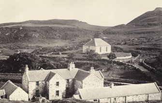 View of Colonsay and Oronsay Parish Church, in the foreground is the current Colonsay Hotel, at Scalasaig, Colonsay.
Titled: '102. Colonsay church and back of Inn.'
PHOTOGRAPH ALBUM NO 186: J B MACKENZIE ALBUMS vol.1