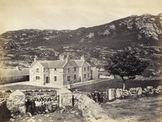 View of Colonsay Hotel, formerly Inn, with a group of children in foreground at Scalasaig, Colonsay.
Titled:  '105. Colonsay Inn'.
PHOTOGRAPH ALBUM NO 186: J B MACKENZIE ALBUM