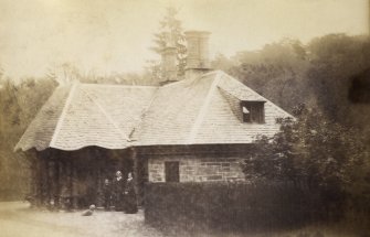 View of Fort Lodge, Taymouth Castle, with family and dog positioned in front.
PHOTOGRAPH ALBUM No. 187, (cf PAs 186 and 188) Rev. J.B. MacKenzie of Colonsay Albums,1870, vol.2.
