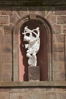 South range. Detail of statue in niche above arched entrance.
