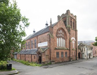 General view of hall and adjacent church from North East.