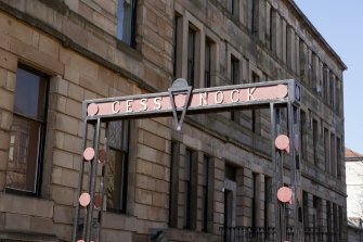 Detail of lettering on a stairhead stantion at the entrance to Cessnock subway station
