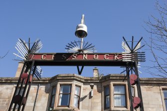 Detail of lettering on stairhead stantion, with later security additions, at Cessnock subway station