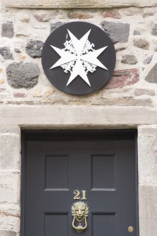 Detail of sign above doorway at St John's Priory, 21 St John's Street, Edinburgh.