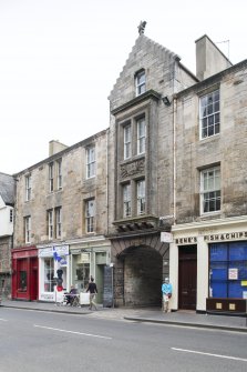 View of arched entrance to Sugarhouse Close through 154-166 Canongate, Edinburgh, from N.