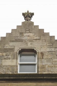 Detail of finial to gable above entrance to Sugarhouse Close at 160 Canongate, Edinburgh.