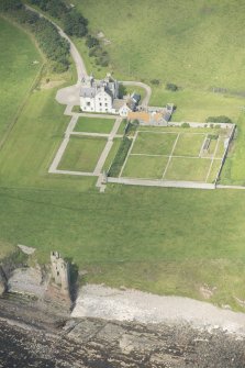Oblique aerial view of Old Keiss Castle, Keiss Castle and walled garden, looking NW.