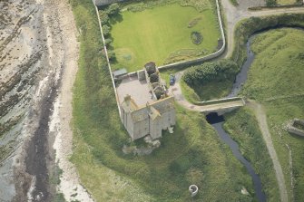 Oblique aerial view of Freswick Castle and bridge, looking SSE.