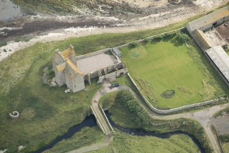 Oblique aerial view of Freswick Castle and bridge, looking E.