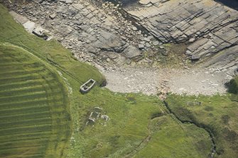 Oblique aerial view of the remains of the building and the kiln barn, looing ESE.