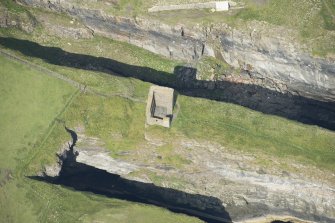 Oblique aerial view of Castle of Old Wick, looking NW.