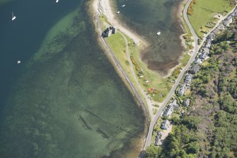 Oblique aerial view of Lochranza castle and fish trap, looking to the E.