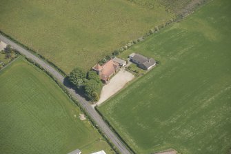Oblique aerial view of St Molio's Church, looking to the E.