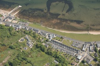 General oblique aerial view of the Hamilton Terrace area of Lamlash with the remains of the harbour adjacent, looking to the E.