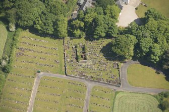 Oblique aerial view of Kilbride Chapel and churchyard, looking to the E.