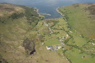 General oblique aerial view of Lochranza centred on the Isle of Arran Distillery and Golf Course, looking to the NW.