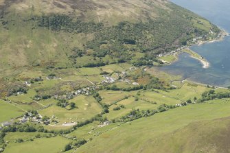 General oblique aerial view of Lochranza centred on Lochranza Golf Course with Lochranza castle adjacent, looking to the WSW.