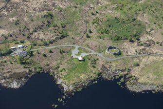 Oblique aerial view of the re-erected site of Loch Doon Castle, looking to the NNW.