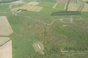 General oblique aerial view of the E part of the Kirkcudbright Training Area centred on the 'figure-of-eight' tracked target at High Barcheskie with Brown Hill and Girdstingwood beyond, looking E.