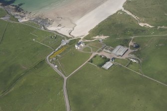 Oblique aerial view of Balnakeil House, Balnakeil Parish Church and Churchyard, looking to the NNW.