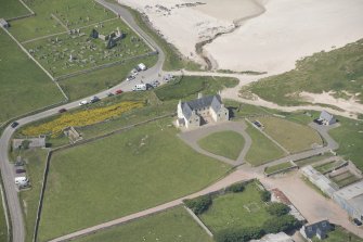 Oblique aerial view of Balnakeil House, Balnakeil Parish Church and Churchyard, looking to the NW.