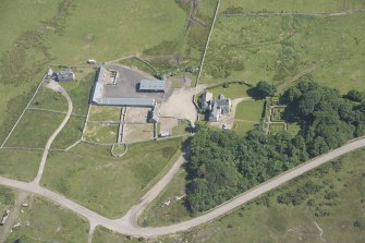 Oblique aerial view of Melness House and Farmstead, looking to the SE.