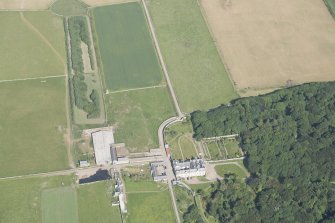 Oblique aerial view of Sandside House, walled garden and Home Farm, looking to the ENE.