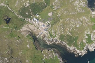 Oblique aerial view of Rispond Fishing Station, pier and quay, looking to the NW.