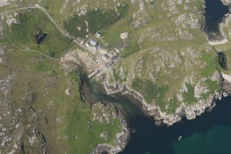 Oblique aerial view of Rispond Fishing Station, pier and quay, looking to the NW.