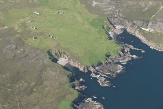 Oblique aerial view of Eilean Nan Ron township buildings and pier, looking to the NW.