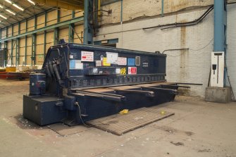 Interior. Central Yard, Steel preparation workshop, 1906 South Bay, East End and 18950s south Bay West end junction.  View of Haemmerlie Guillotine machine. (maximum plate width 3.05m).