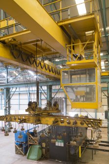 Interior. Central Yard, Steel preparation workshop, North Bay (1950s), East End. View of magnetic lift attached to a 7500Kg crane and travelling overhead crane to which it is attached. The operators cab is on the right.