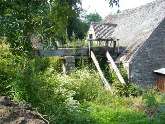 Exterior view of out-building and sluice, from a Standing Building Survey, Glamis Mill, Glamis, Angus.