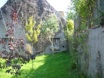 Exterior view of the mill showing gable end ground floor windows and door, from a Standing Building Survey, Glamis Mill, Glamis, Angus.