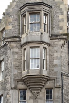 Detail of fourth- and fifth-floor oriel window on corner block at 274-278 Canongate and 2 and 4 St Mary's Street, Edinburgh.