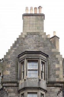 Detail of crowstepped gable on corner block at 274-278 Canongate and 2 and 4 St Mary's Street, Edinburgh.