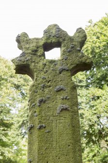 Detail of west face of cross head with carved hammer.