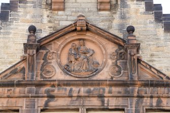 Detail of carved pediment with date '1886' in gable on front elevation of Milton House School, 86 Canongate, Edinburgh.