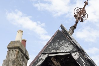 Elevated view from crane, showing detail of gablehead finial and top of chimney stack.