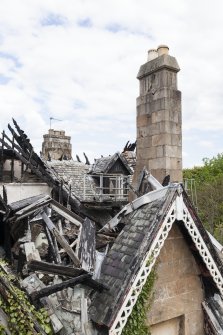 Elevated view from crane, showing fire damaged gable and chimney stack.