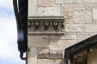 Detail of carved string course on west elevation.